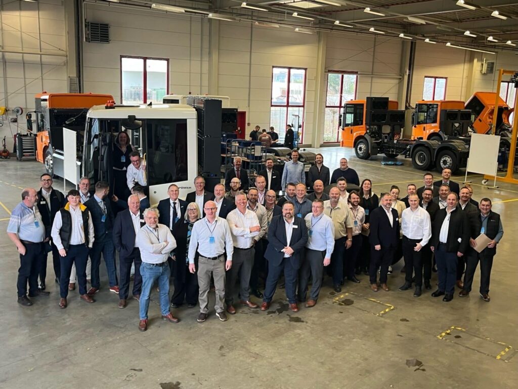 Image of staff and clients in front of ENGINIUS BLUEPOWER truck